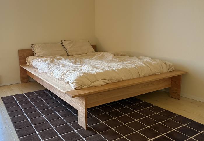 Platform bed with headboard on a tiled rug