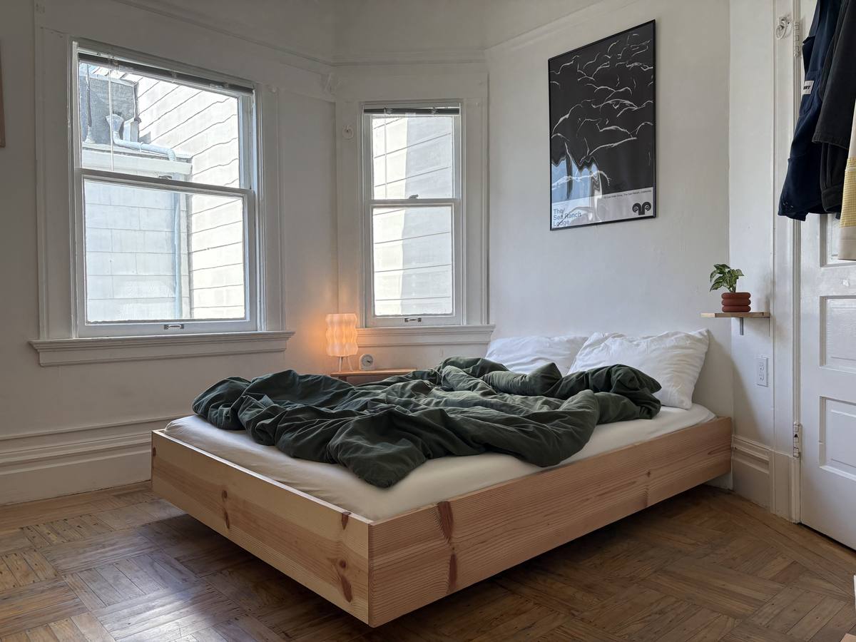 Solid pine platform bed in a bay-window bedroom